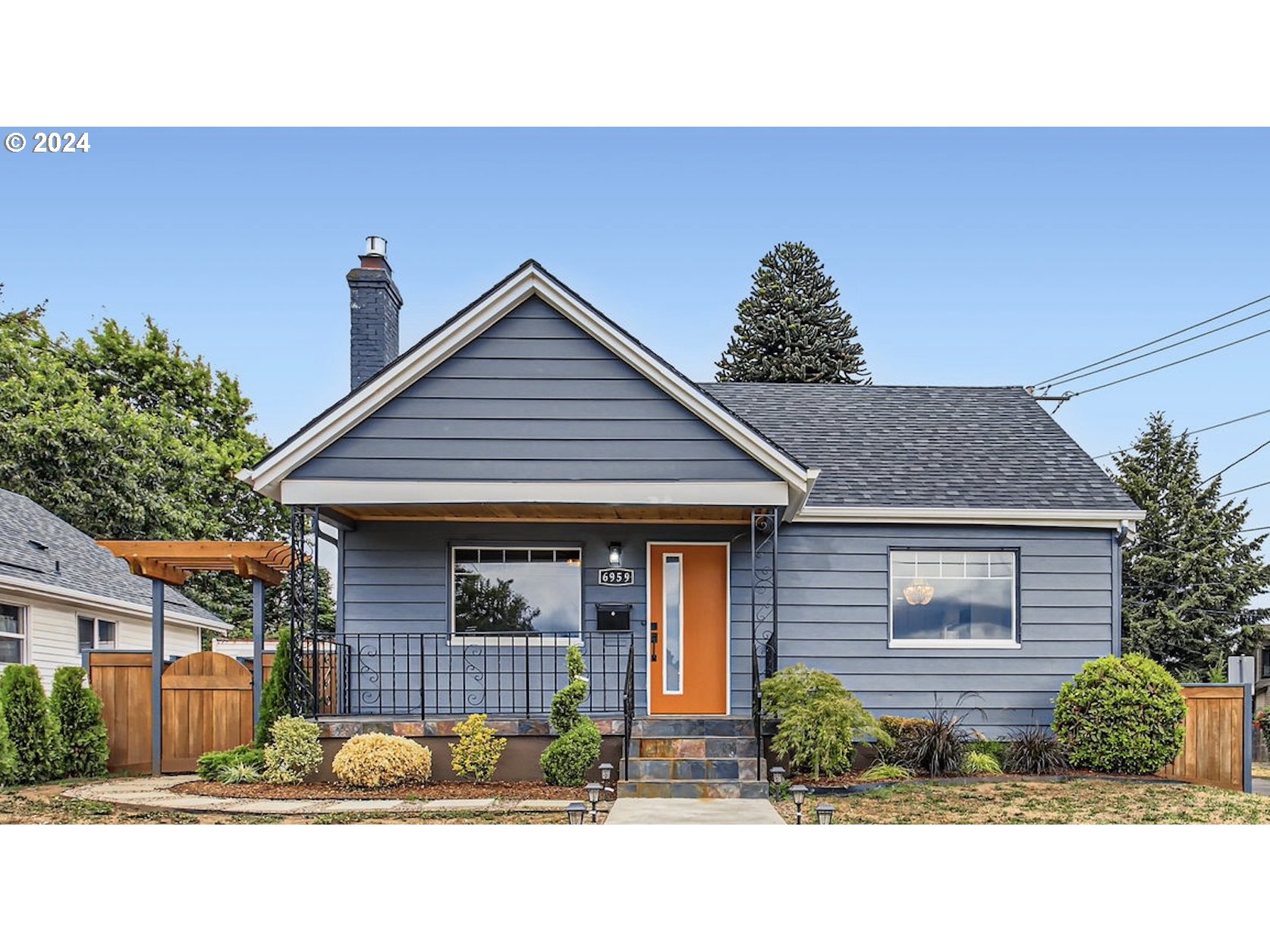 a front view of a house with a garden