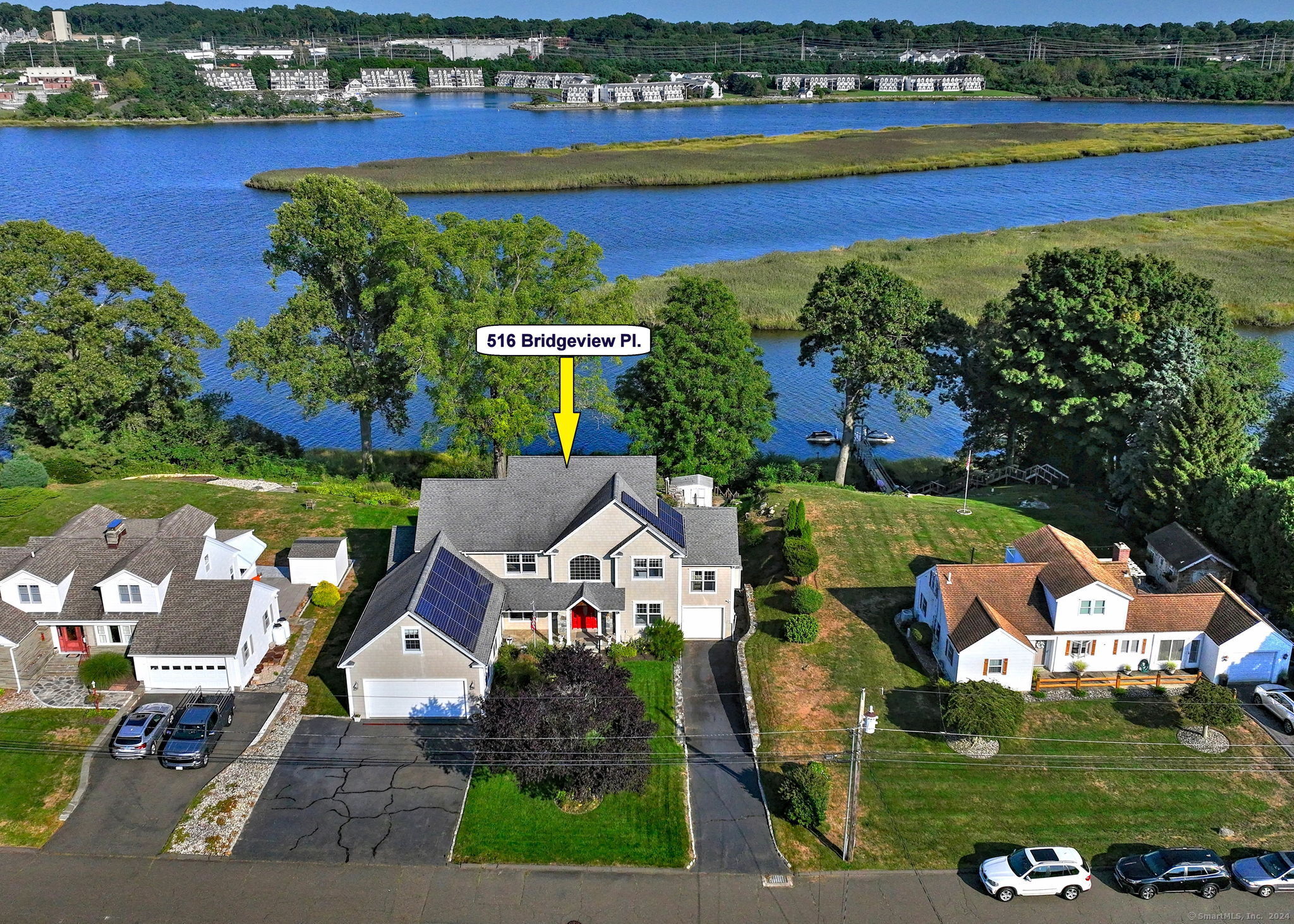 an aerial view of a house with a garden and lake view