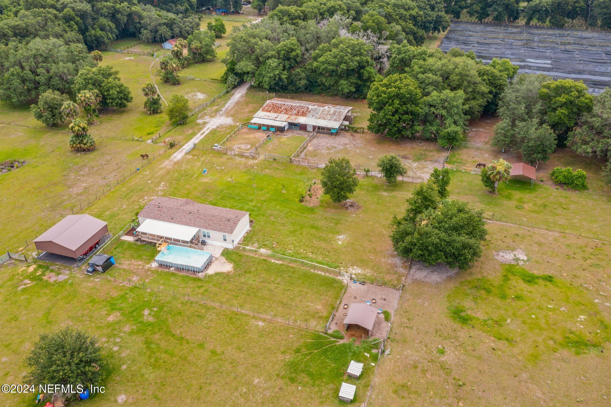 an aerial view of a house with a swimming pool