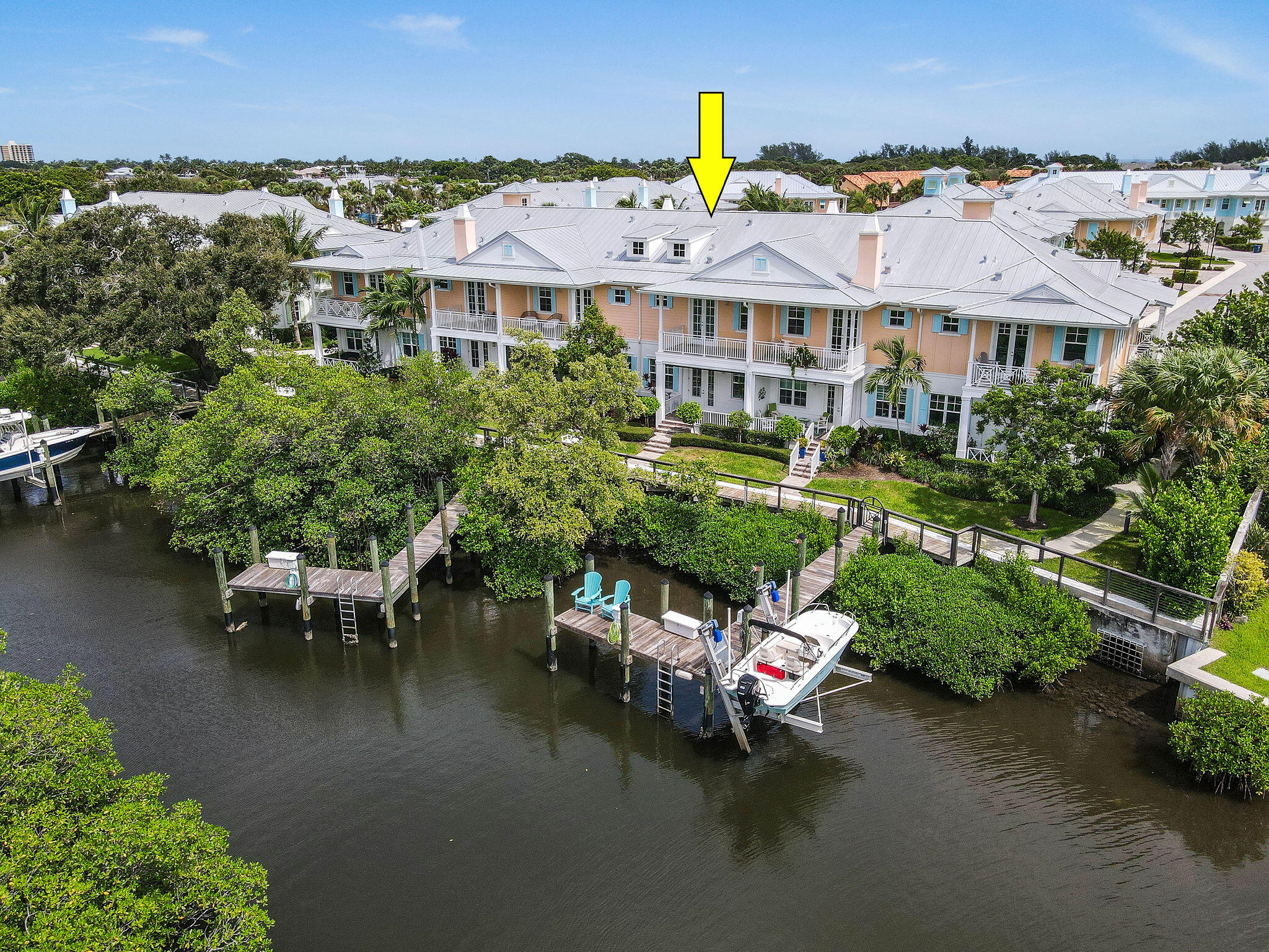 an aerial view of a house with swimming pool patio and outdoor seating