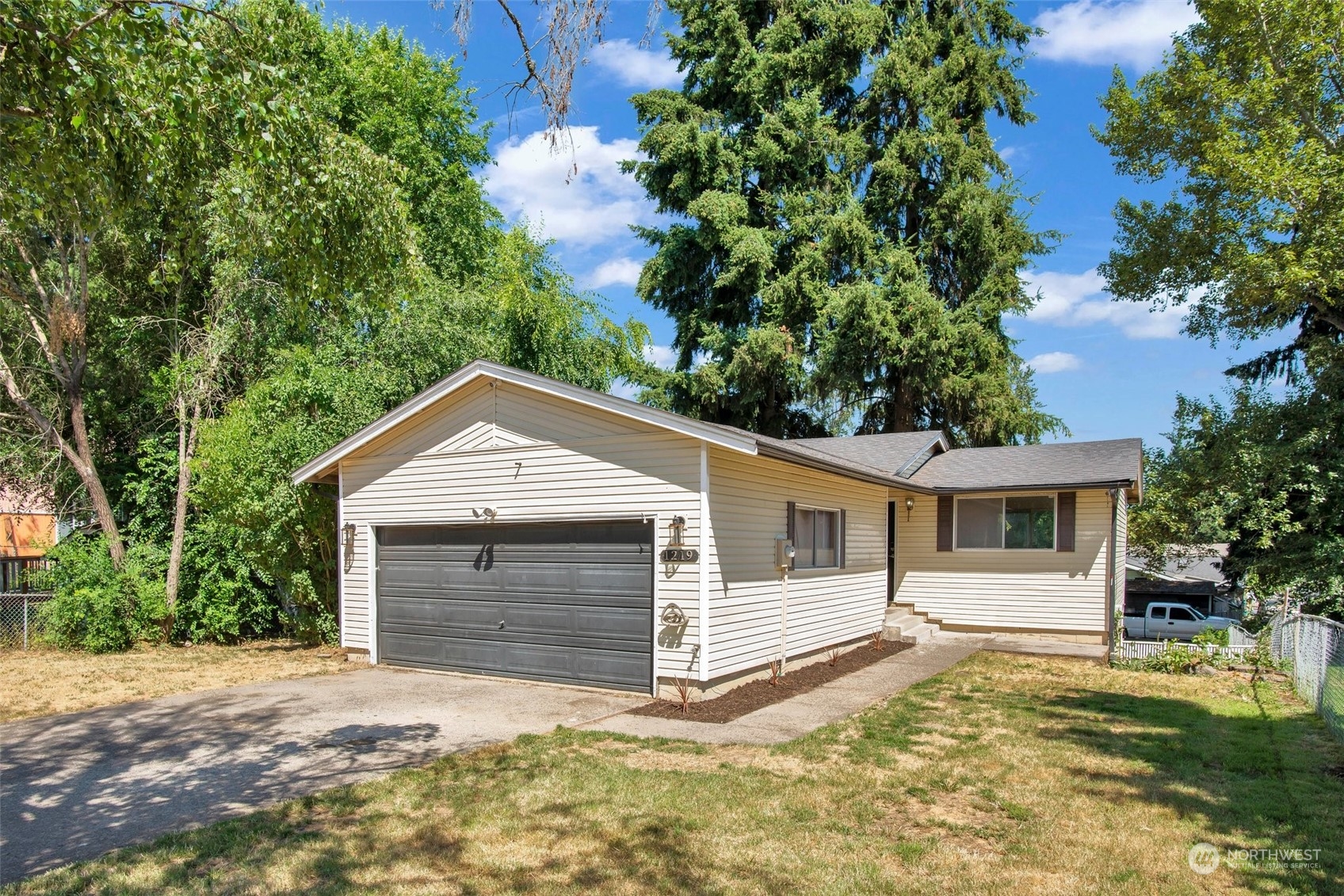 a front view of a house with a yard and garage