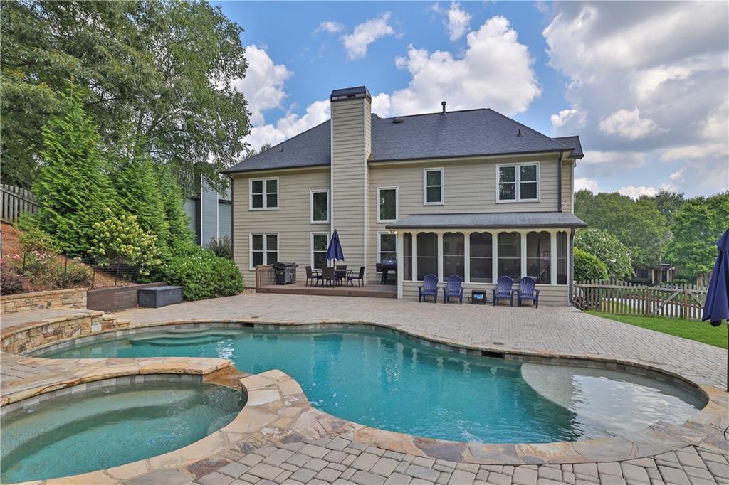 a view of a house with swimming pool and sitting area