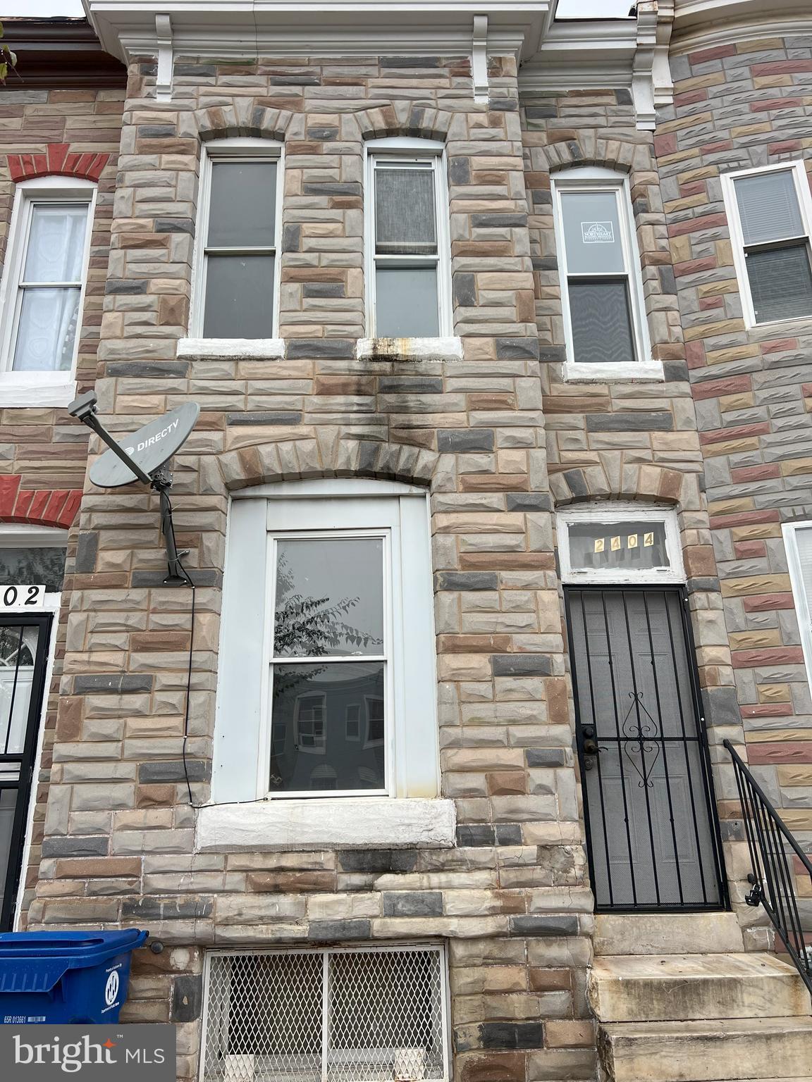 a view of a brick house with large windows