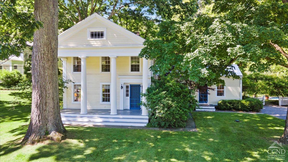 a front view of a house with a garden