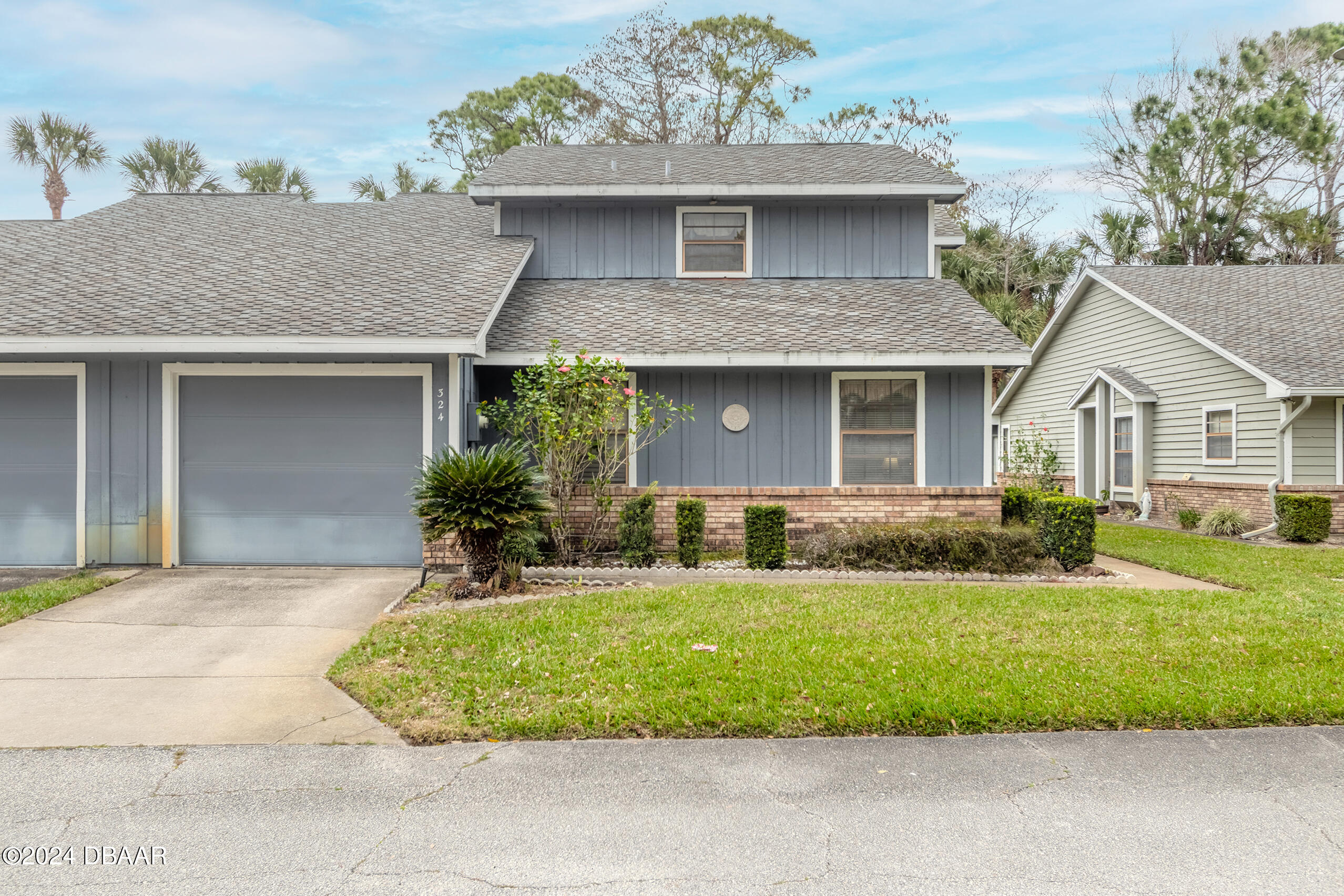 a front view of a house with a yard and garage