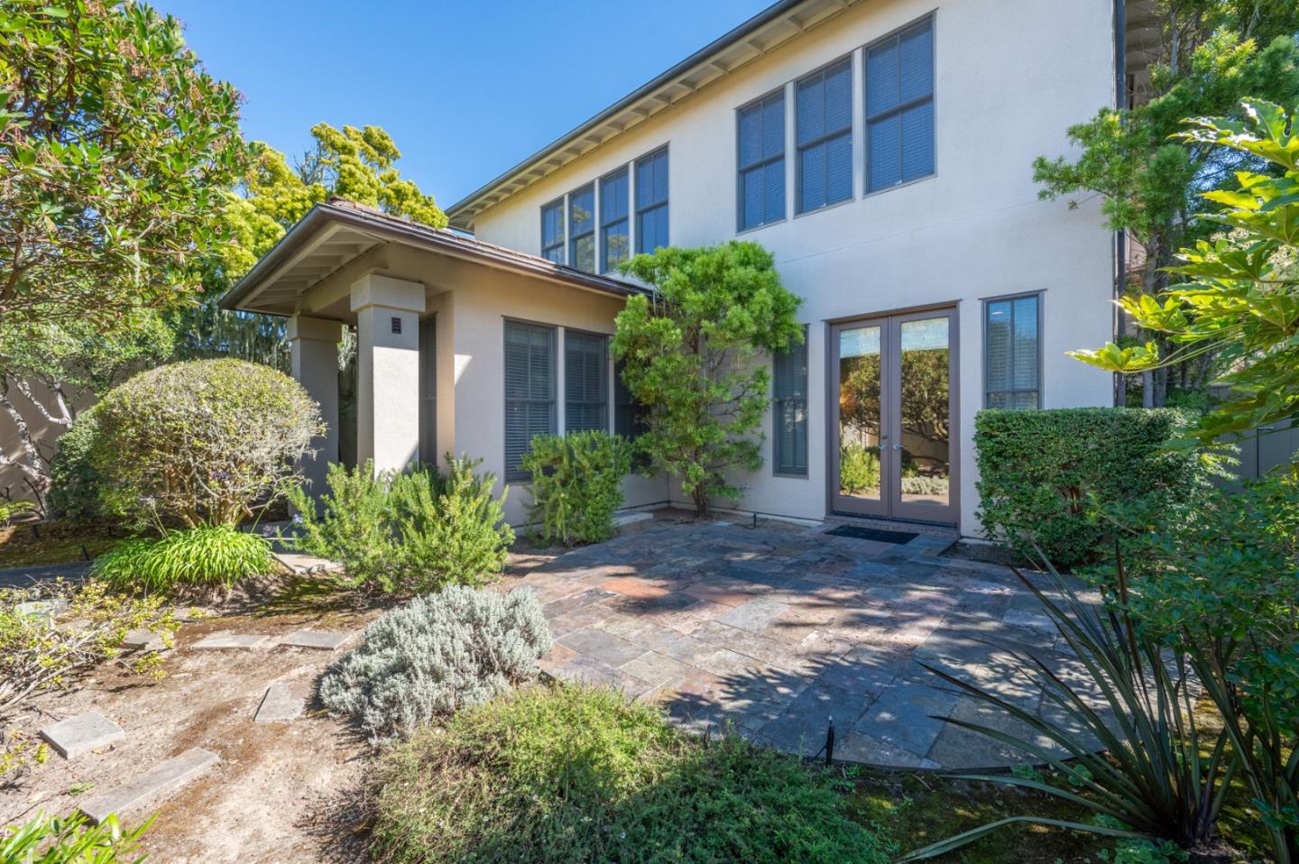 a front view of a house with garden