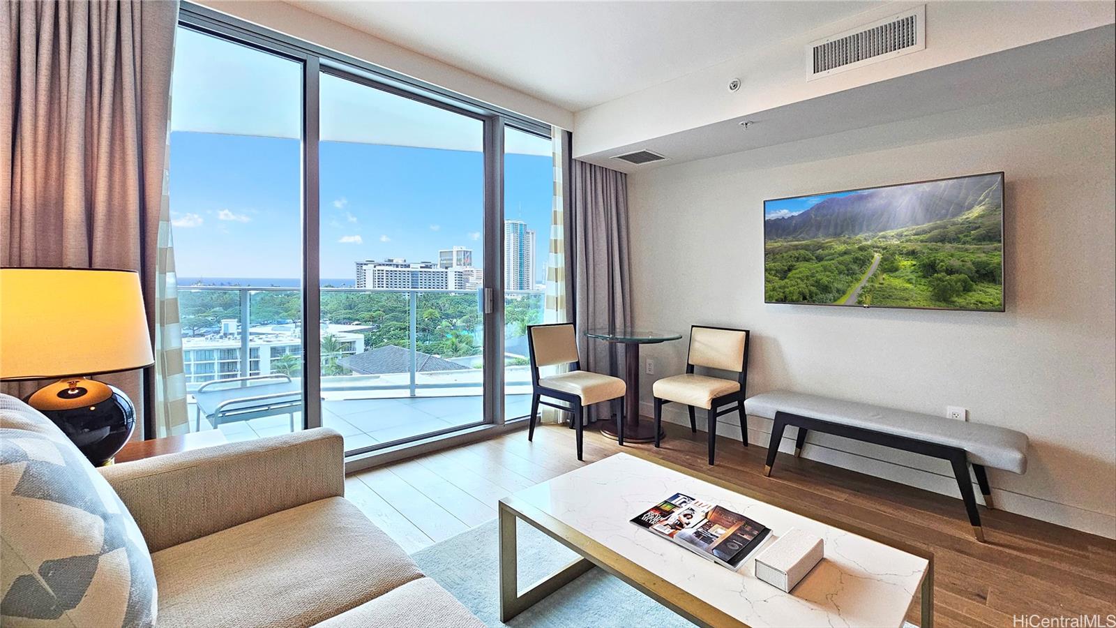 a living room with furniture and a floor to ceiling window