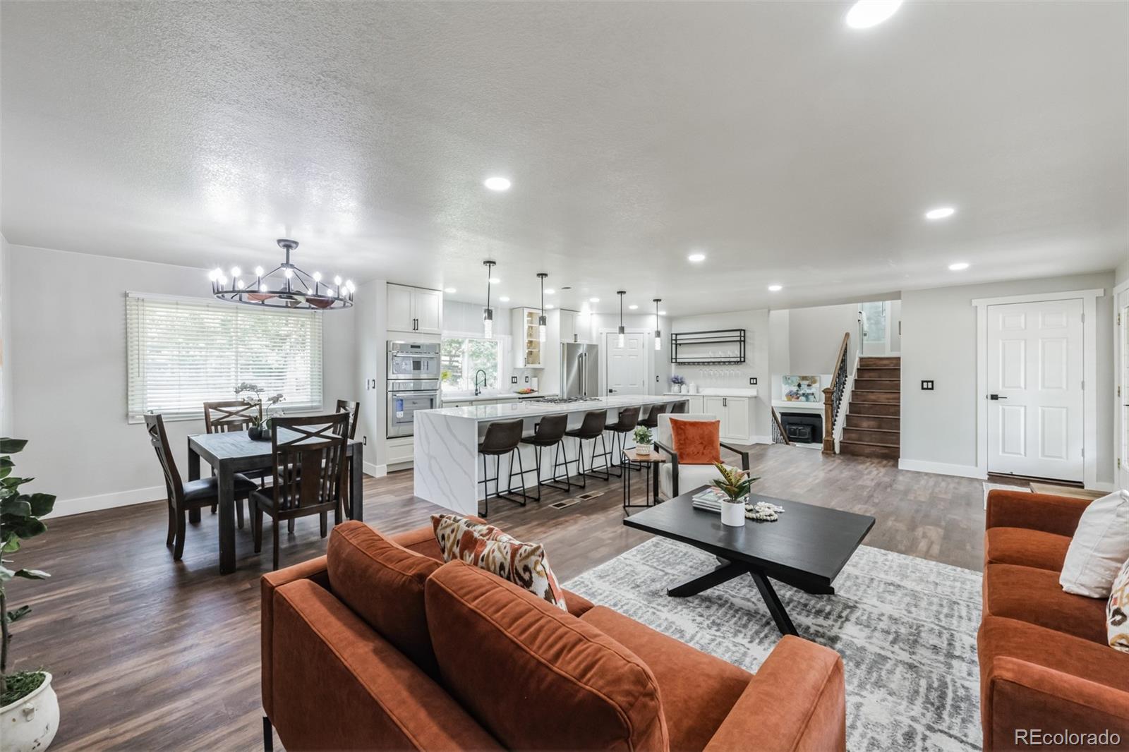 a living room with furniture kitchen view and a dining table