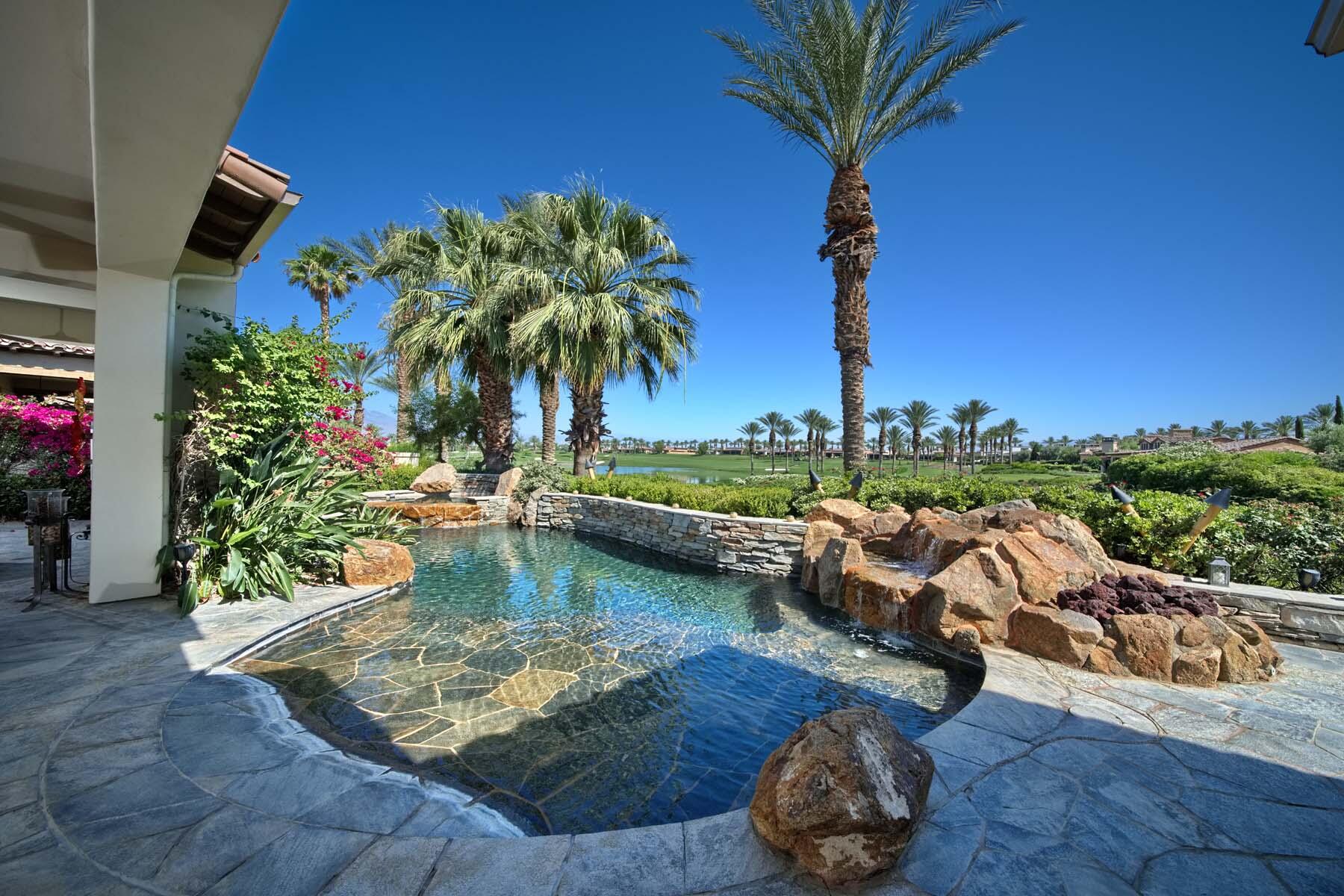 a view of a swimming pool with a patio and a garden