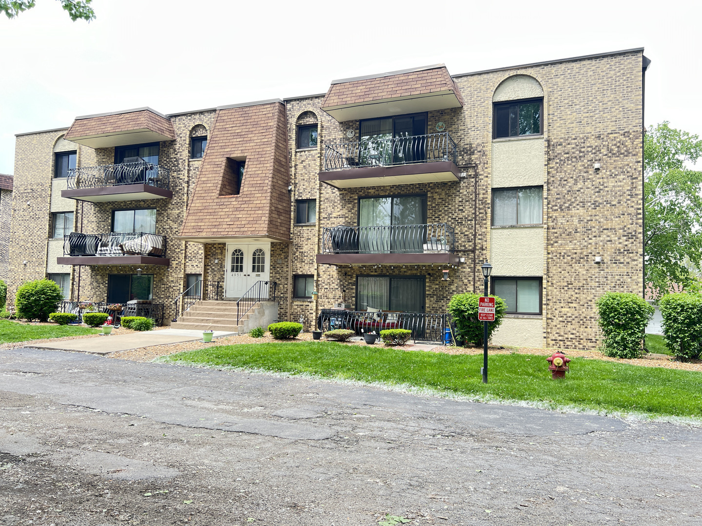 a brick building with a yard in front of it