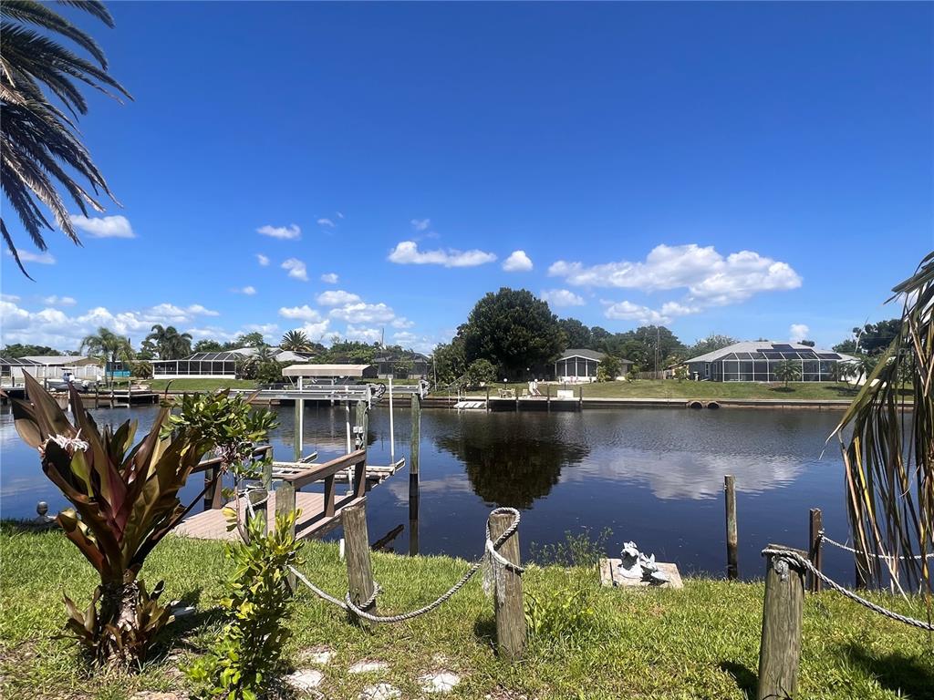 a view of a lake with a house in the background