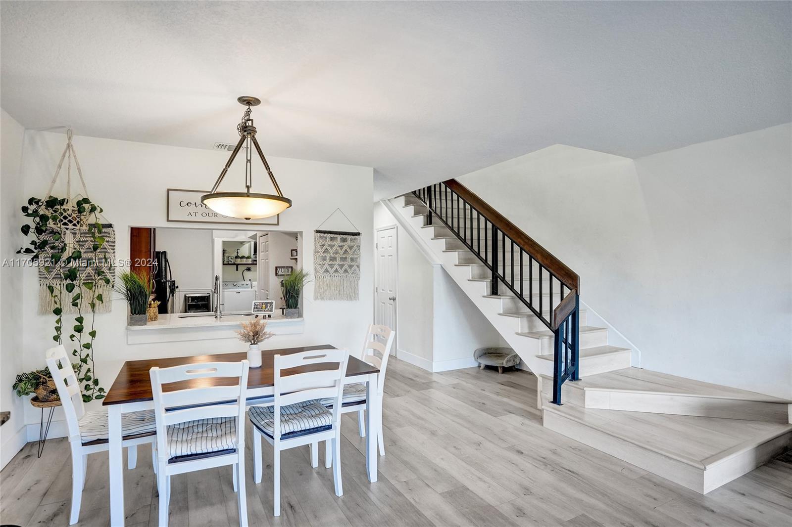 a view of a dining room with furniture wooden floor and staircase