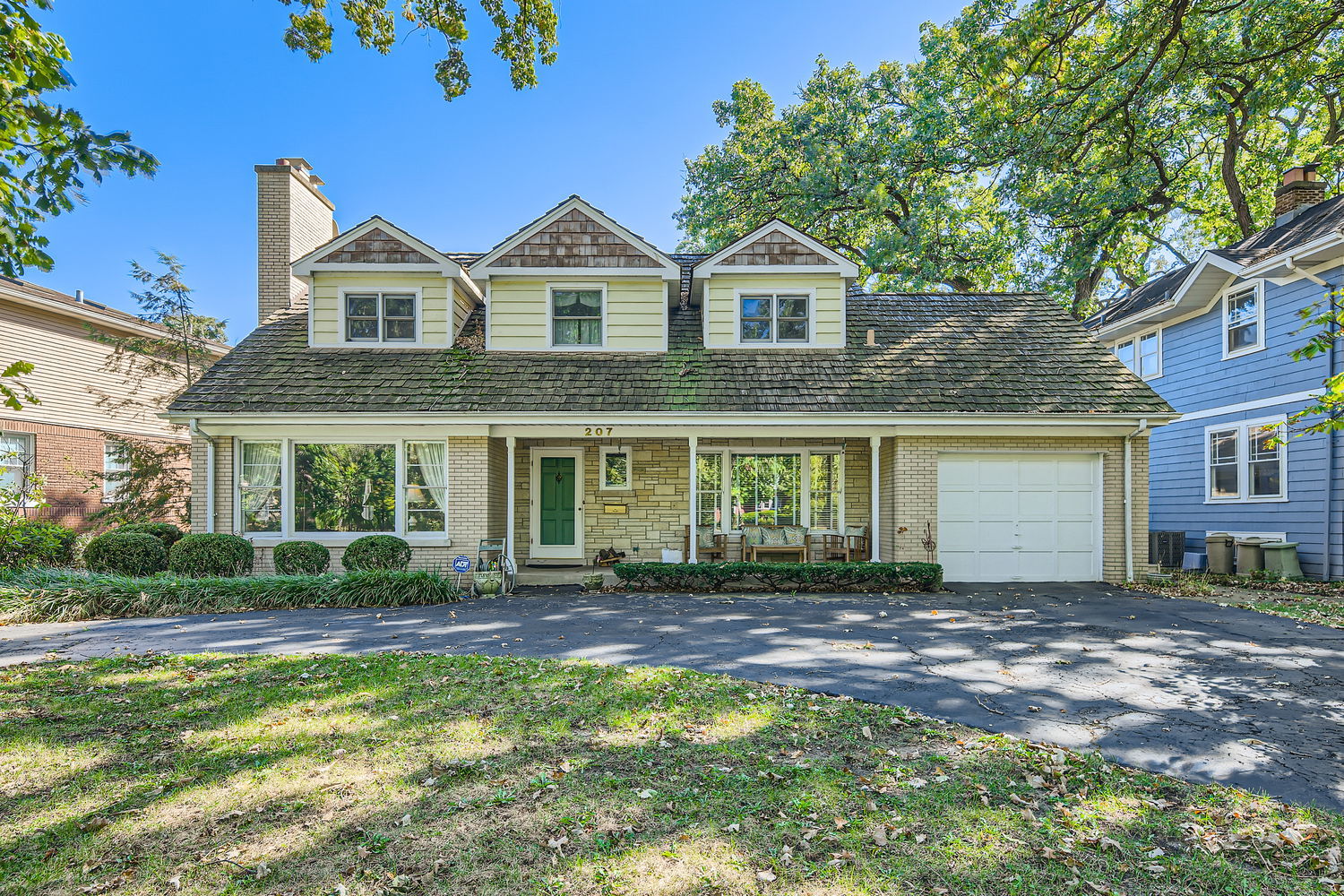 a front view of a house with a garden