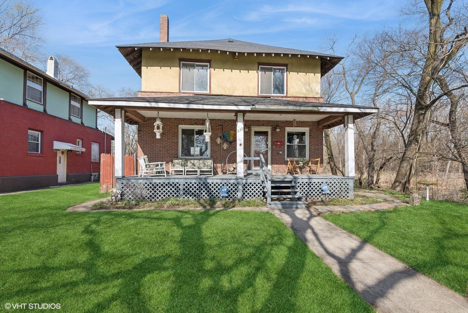 a view of a house with a yard porch and sitting area