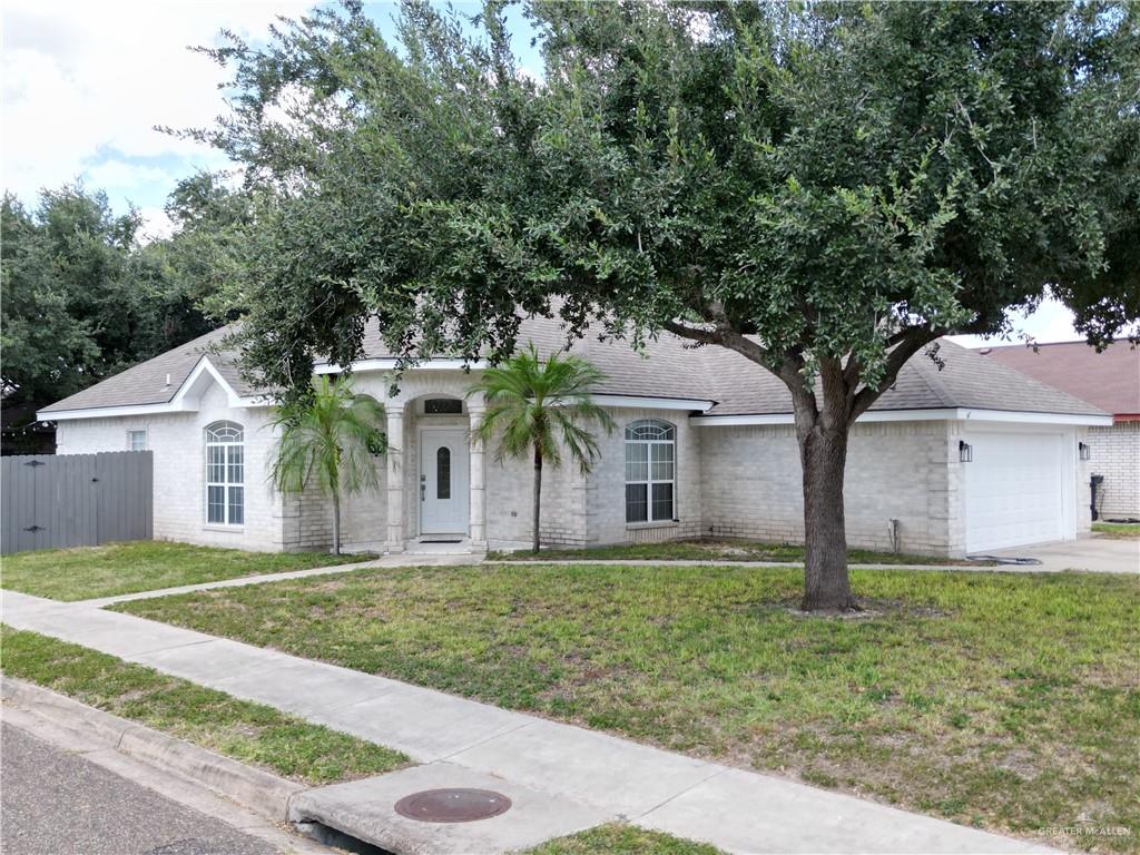 View of front of home with a garage and a front yard