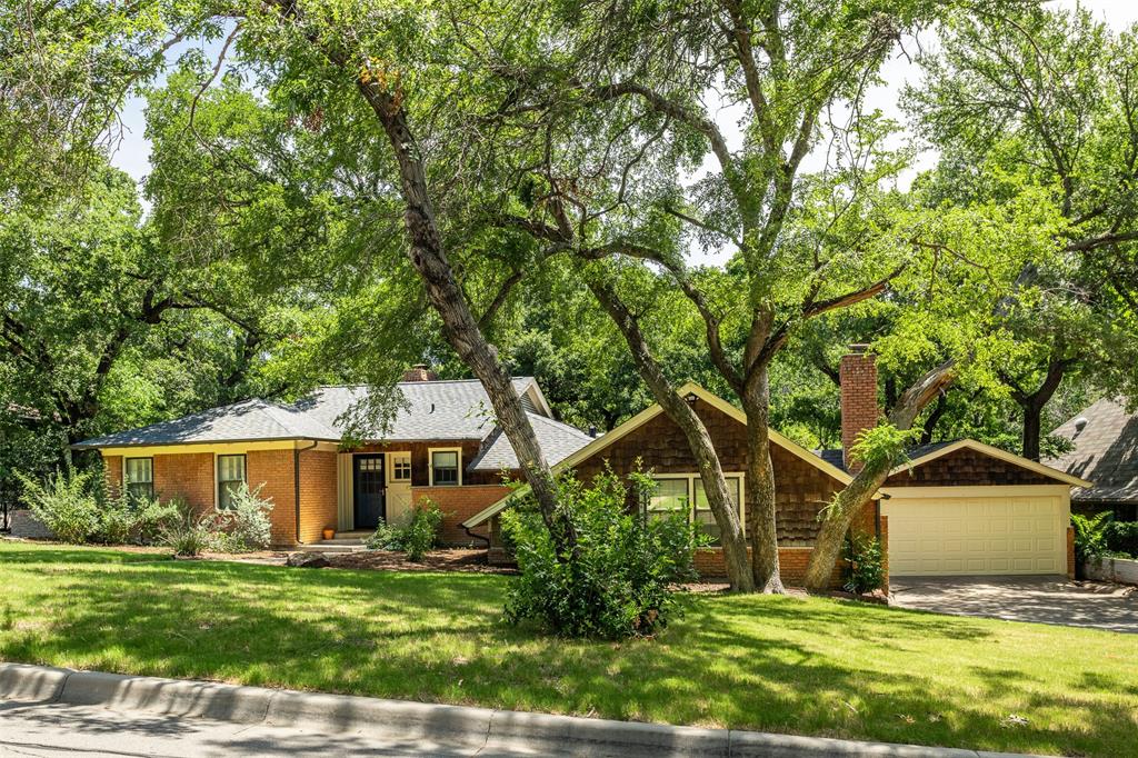 a house that has a tree in front of a house