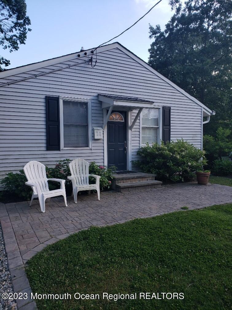 a backyard of a house with table and chairs