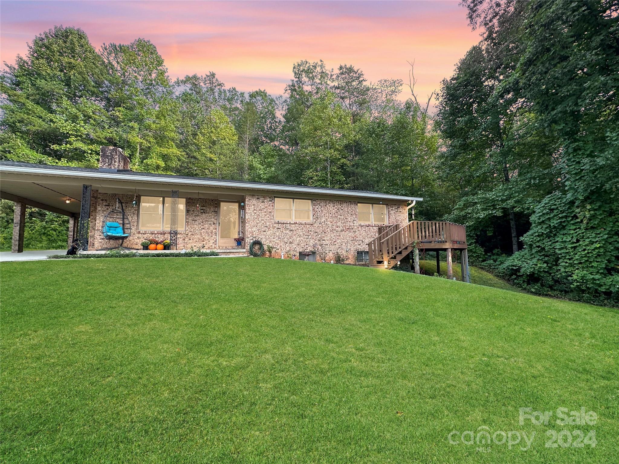 a front view of house with yard outdoor seating and green space