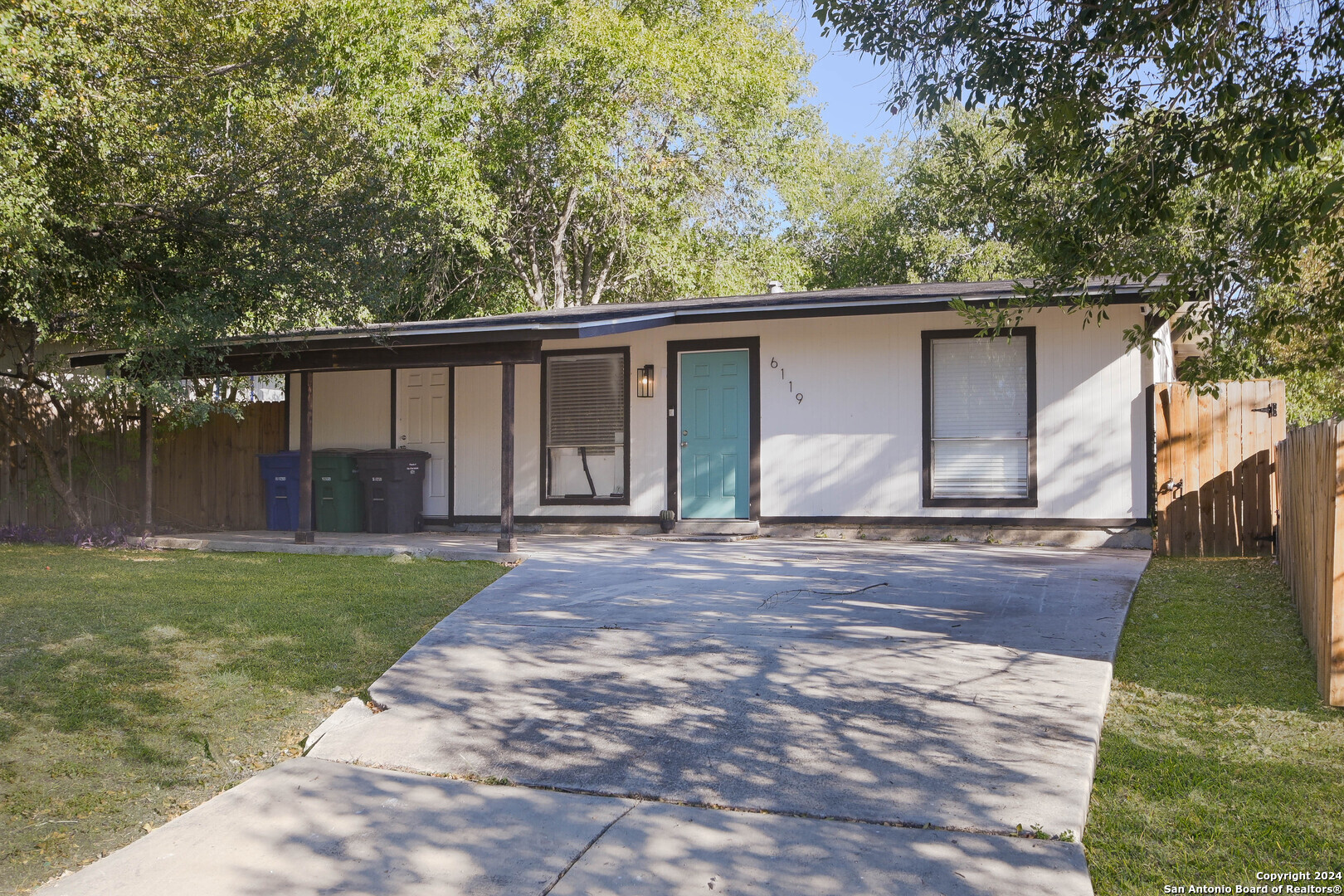 a front view of house with yard and trees