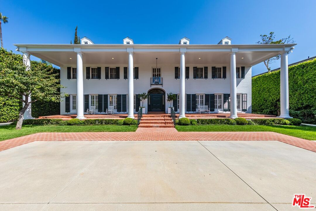 front view of a brick house next to a yard