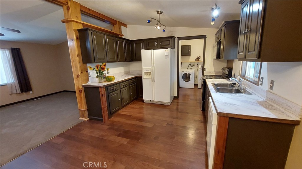 a kitchen with a refrigerator sink and wooden cabinets