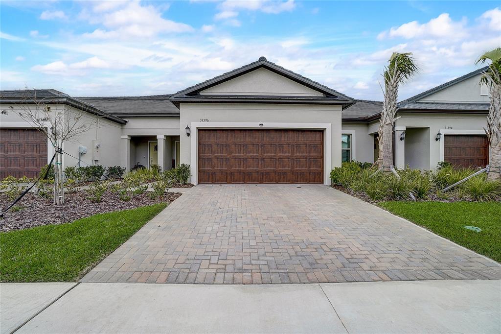 a front view of a house with a yard and garage