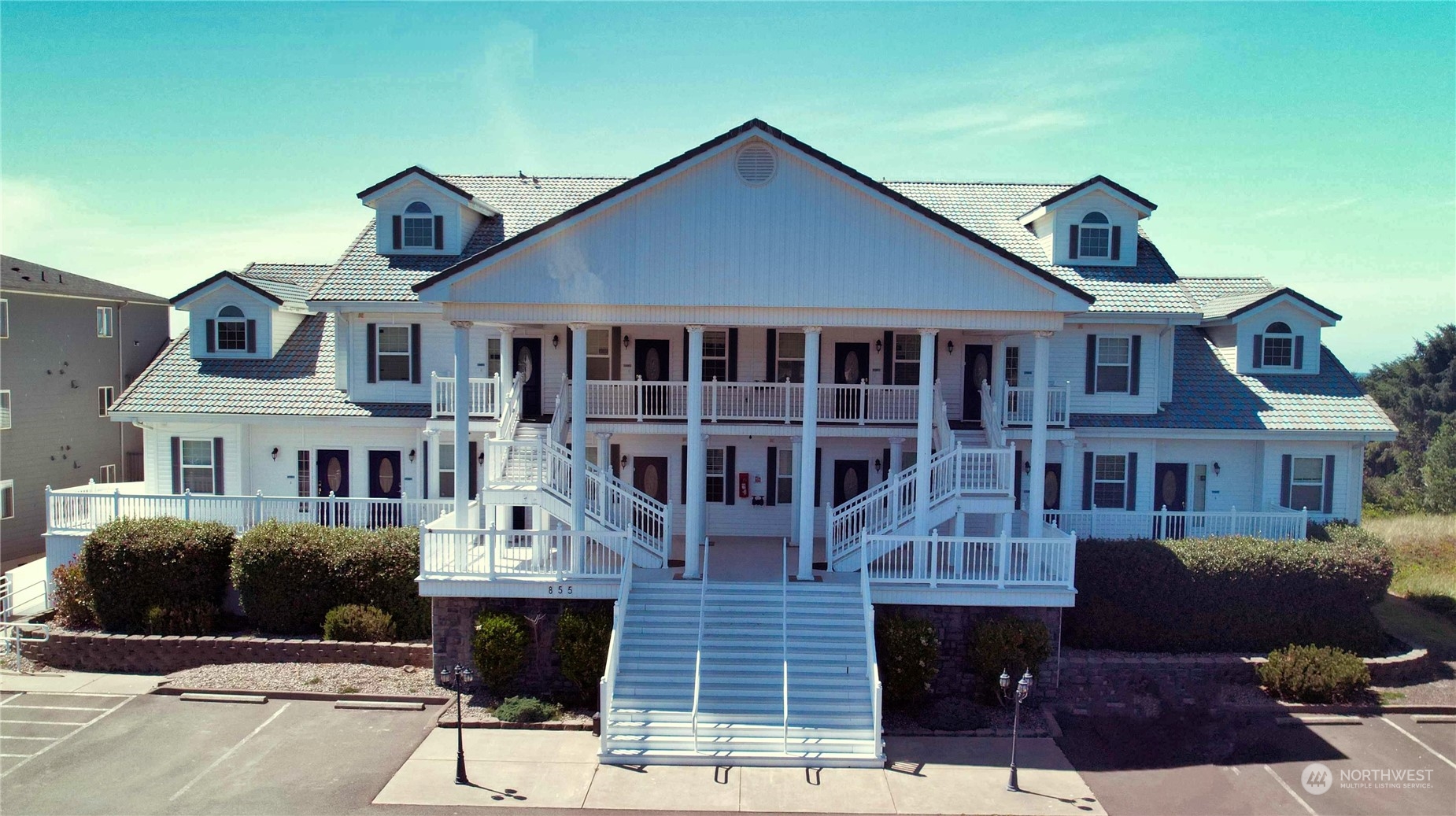 a front view of a house with a garden