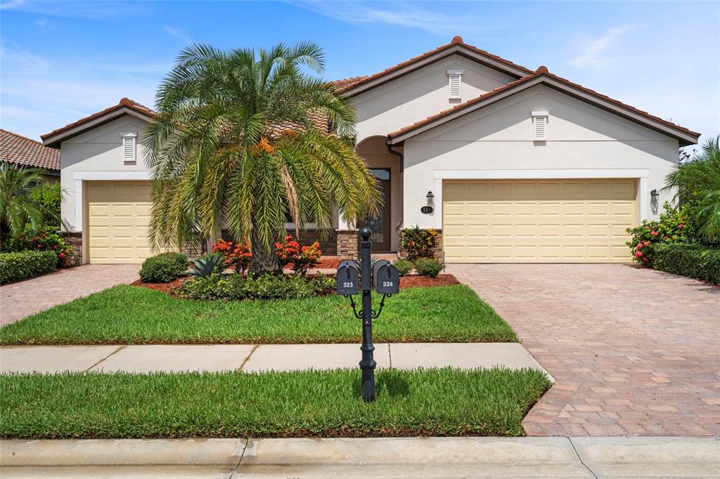 a front view of a house with a garden