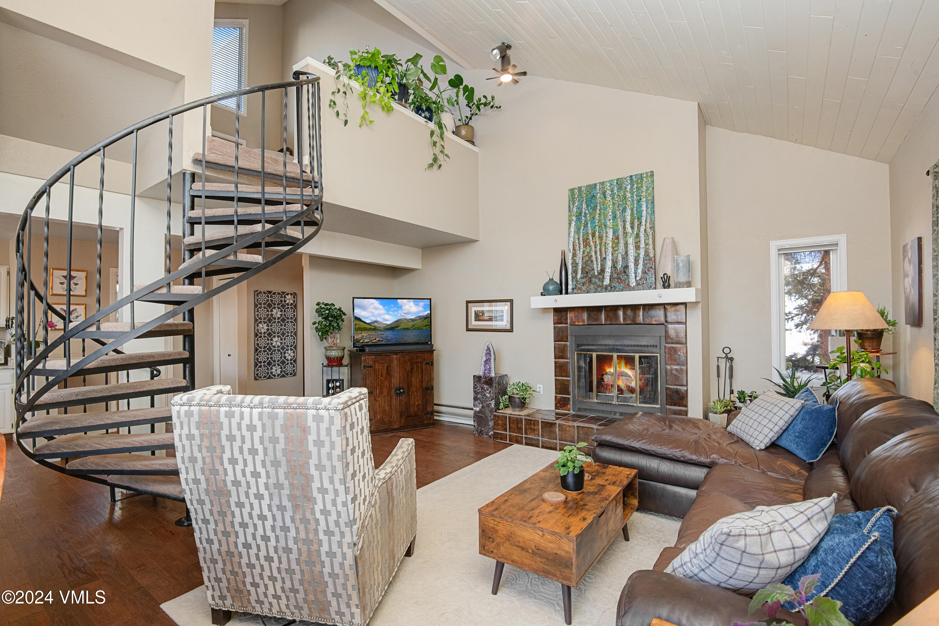 a living room with furniture a fireplace and a window