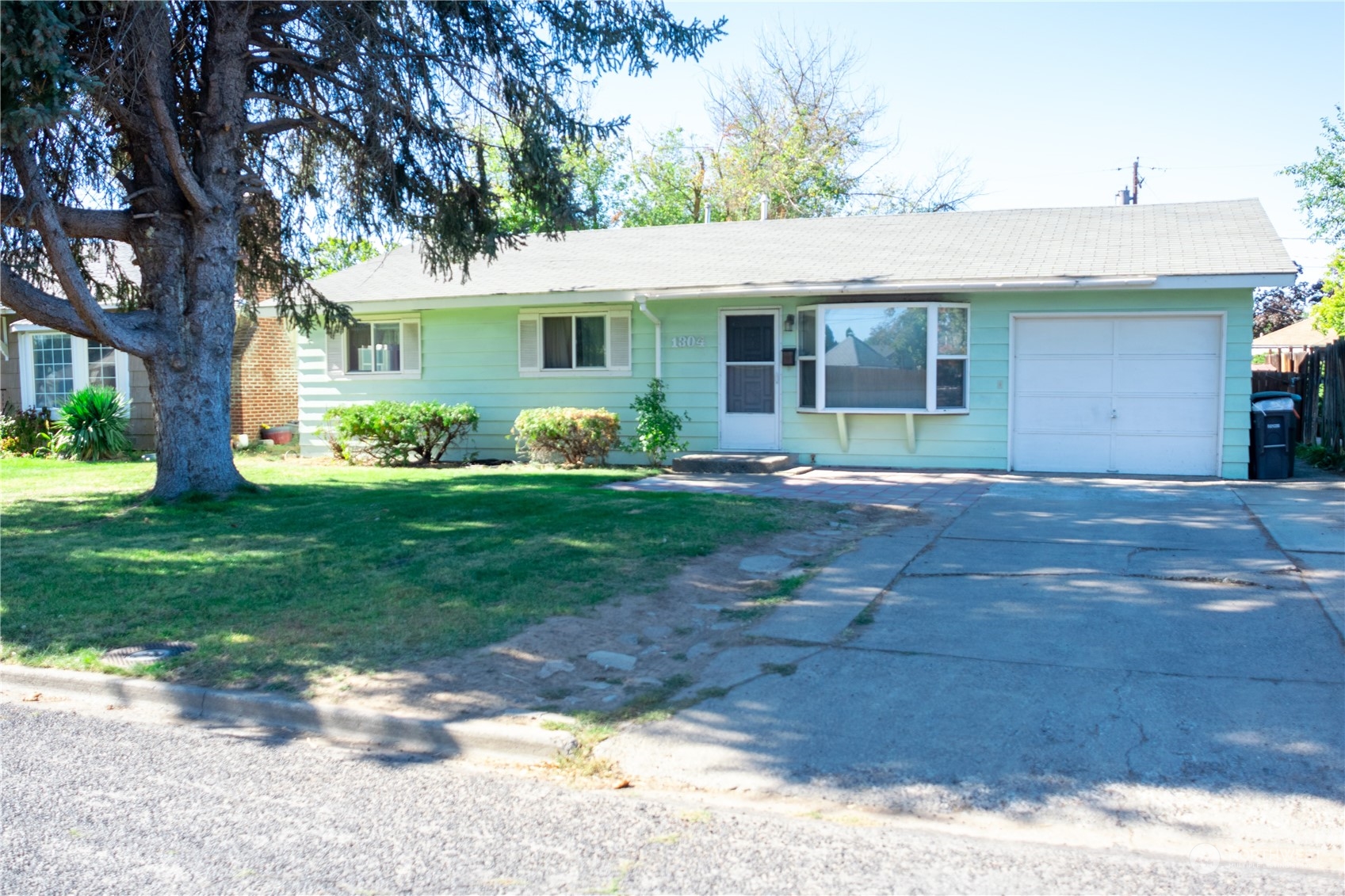 a front view of a house with a yard and porch