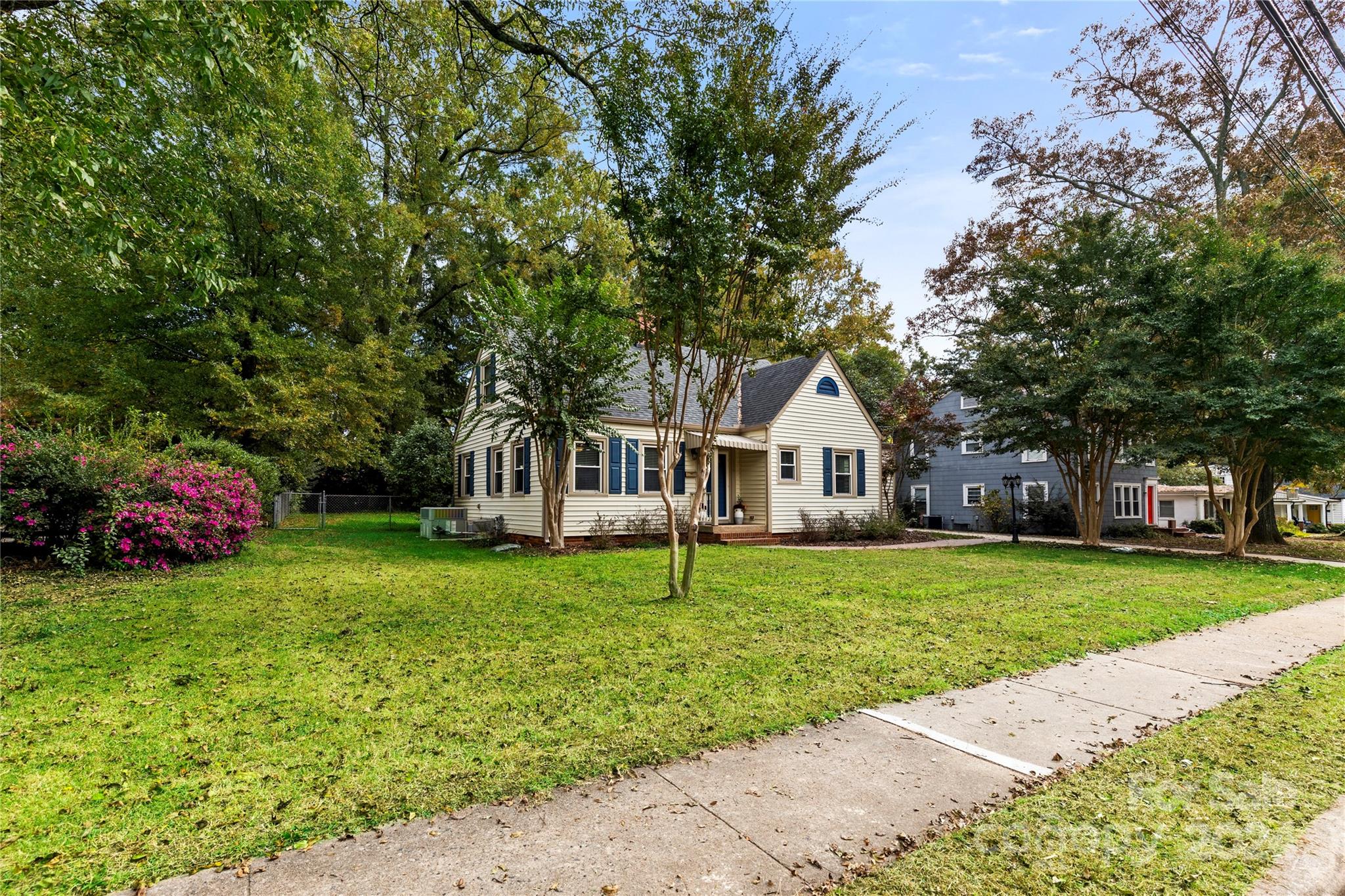 a house with a big yard and large trees