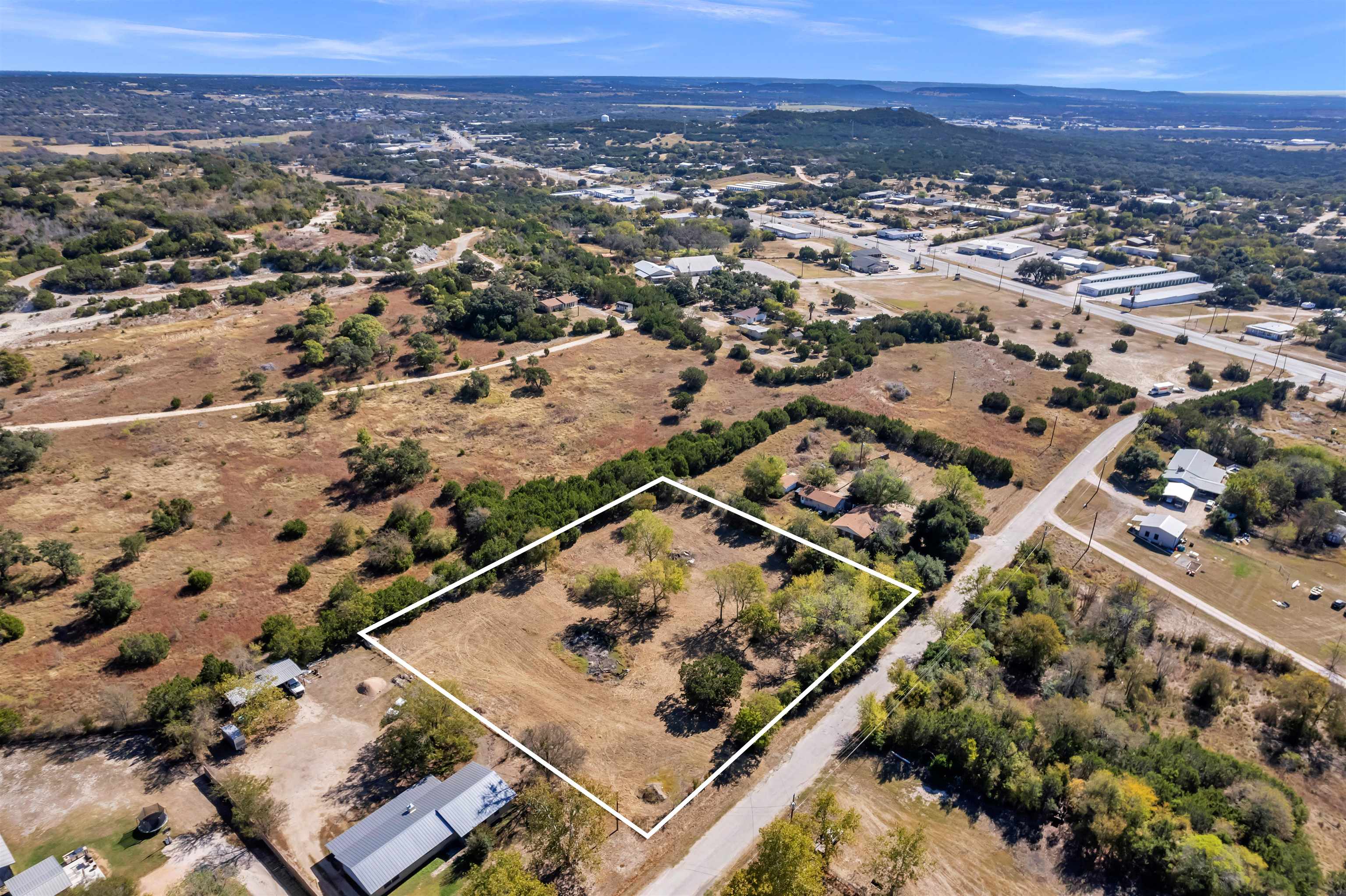 an aerial view of multiple houses with a mountain