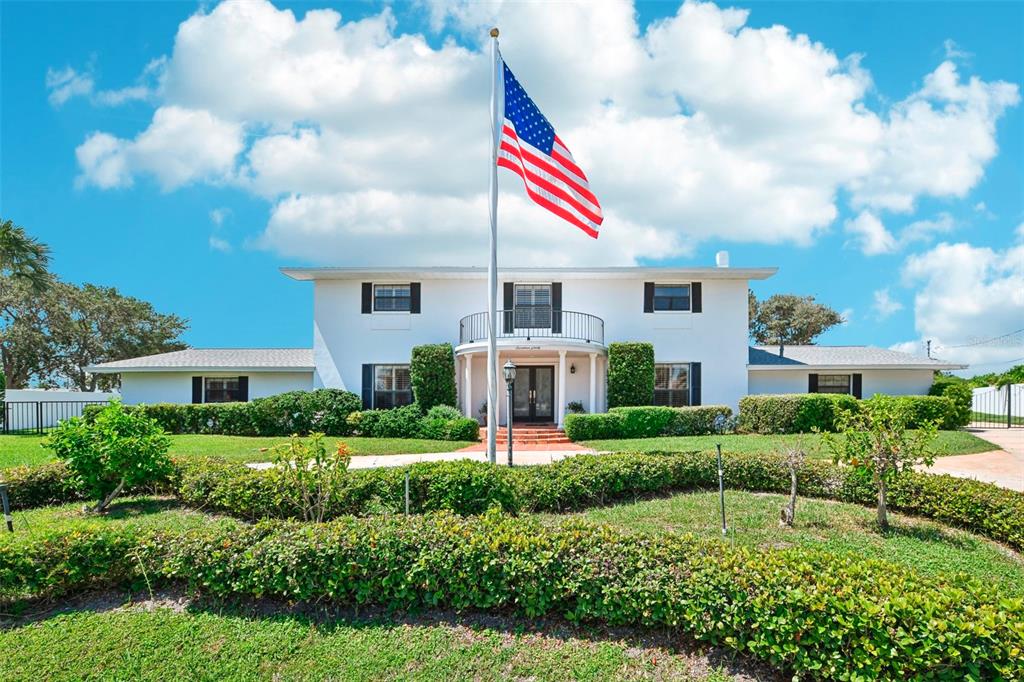 a front view of house with yard and green space