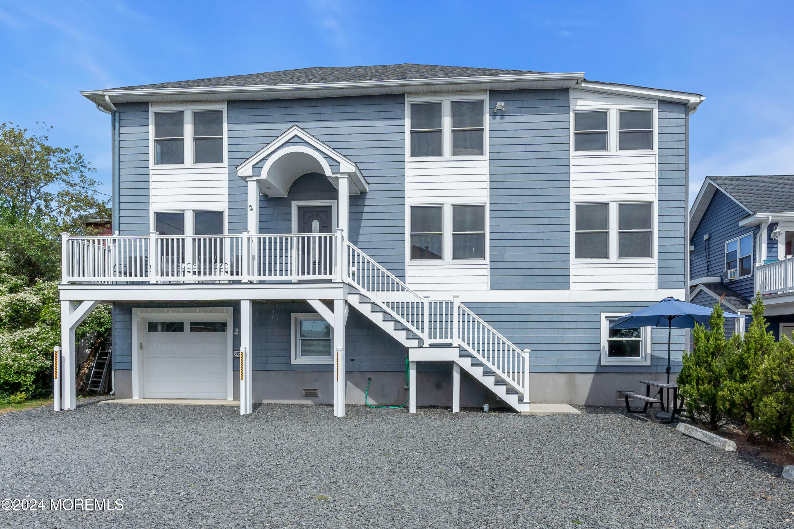 a front view of a house with a balcony and ceiling fan