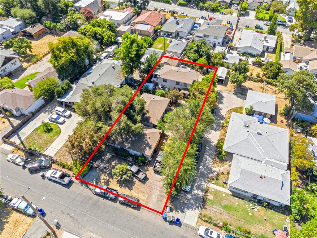 an aerial view of residential house with outdoor space and parking