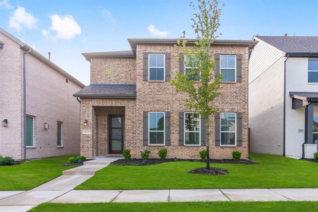 a view of a brick house with a yard