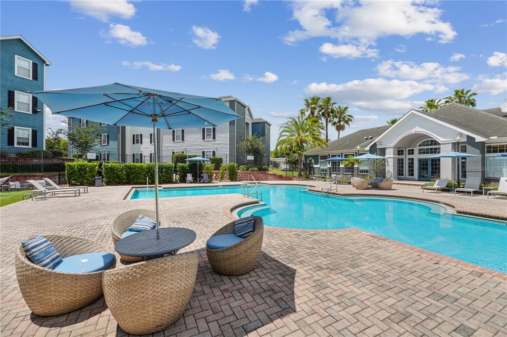 a swimming pool with outdoor seating and yard