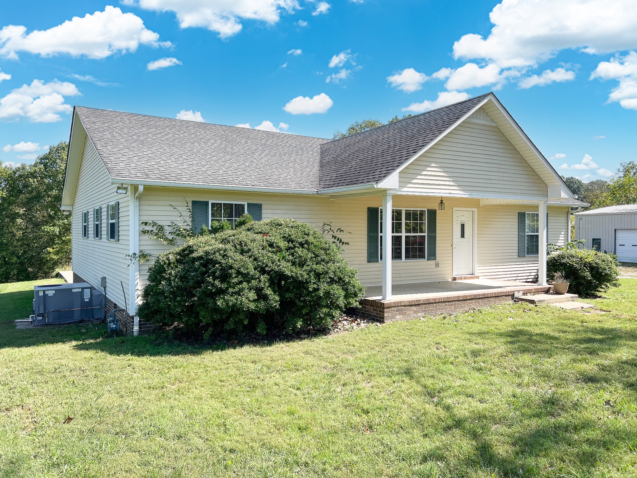 a front view of a house with a yard and porch