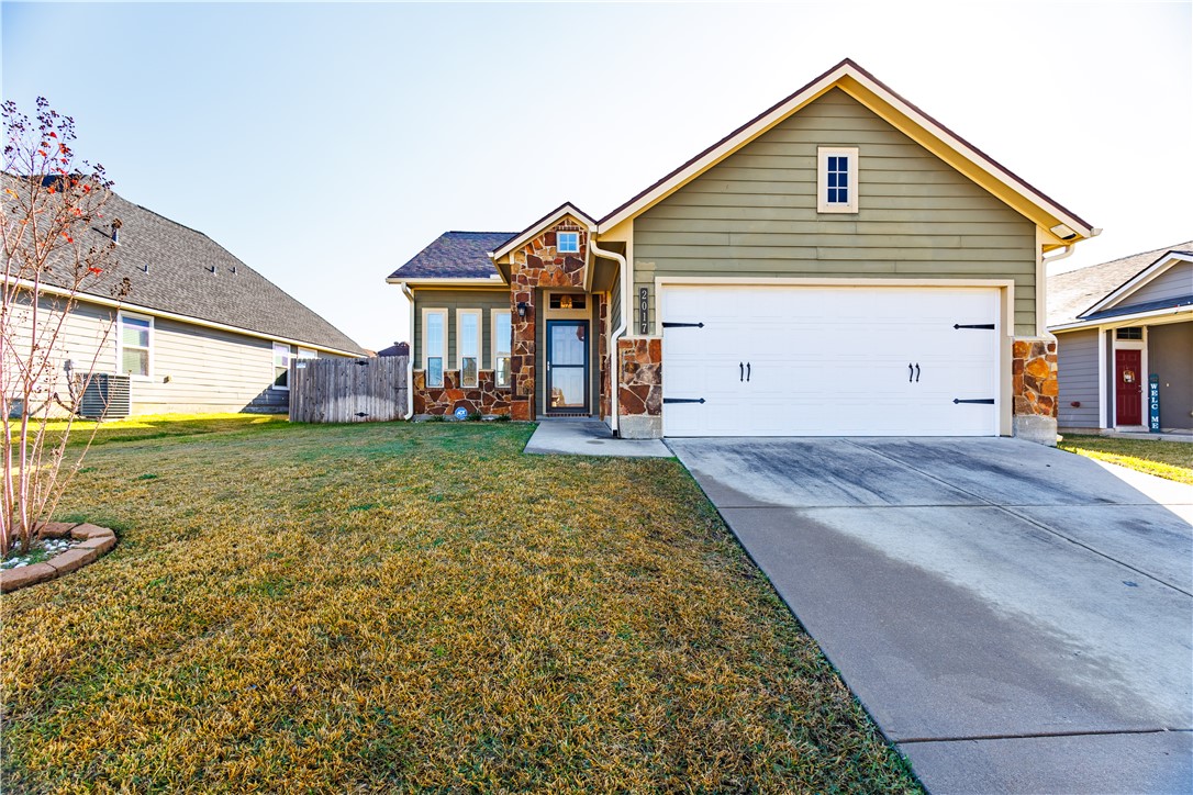 View of front of property featuring a garage and a