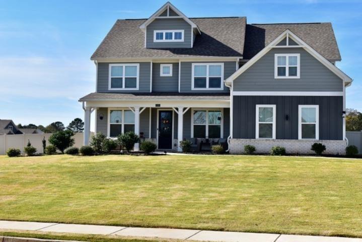 a view of a brick house with a swimming pool