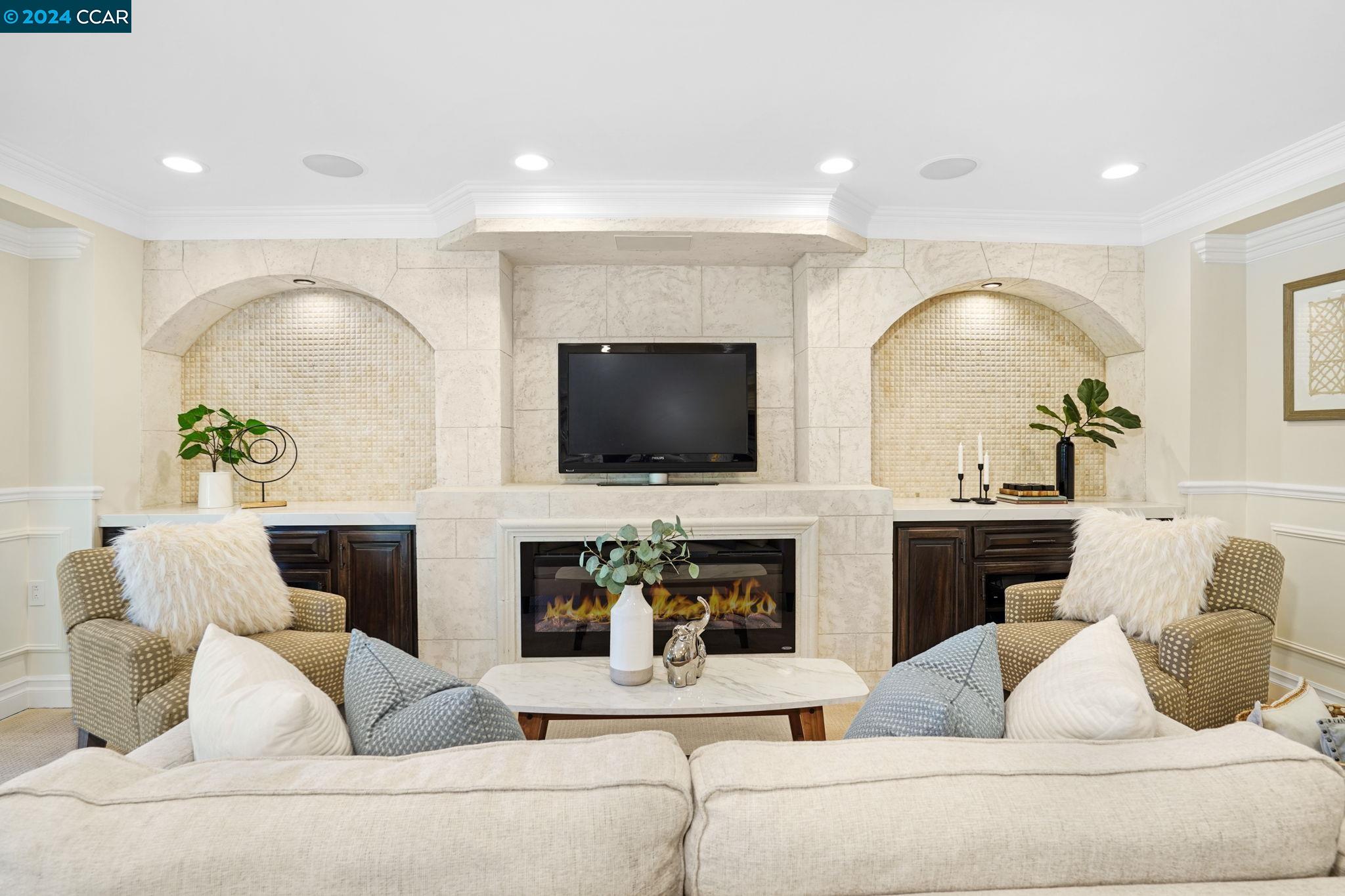 a living room with fireplace furniture and a flat screen tv