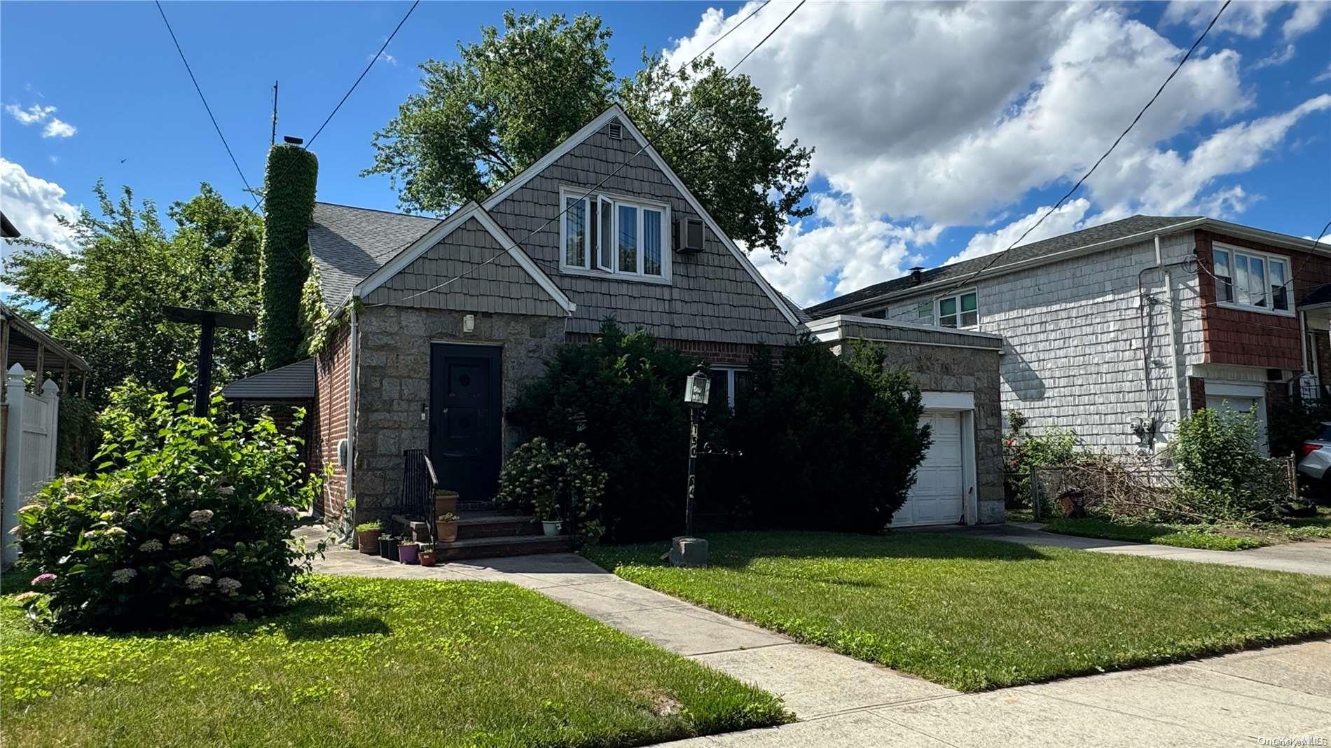 a front view of a house with a garden