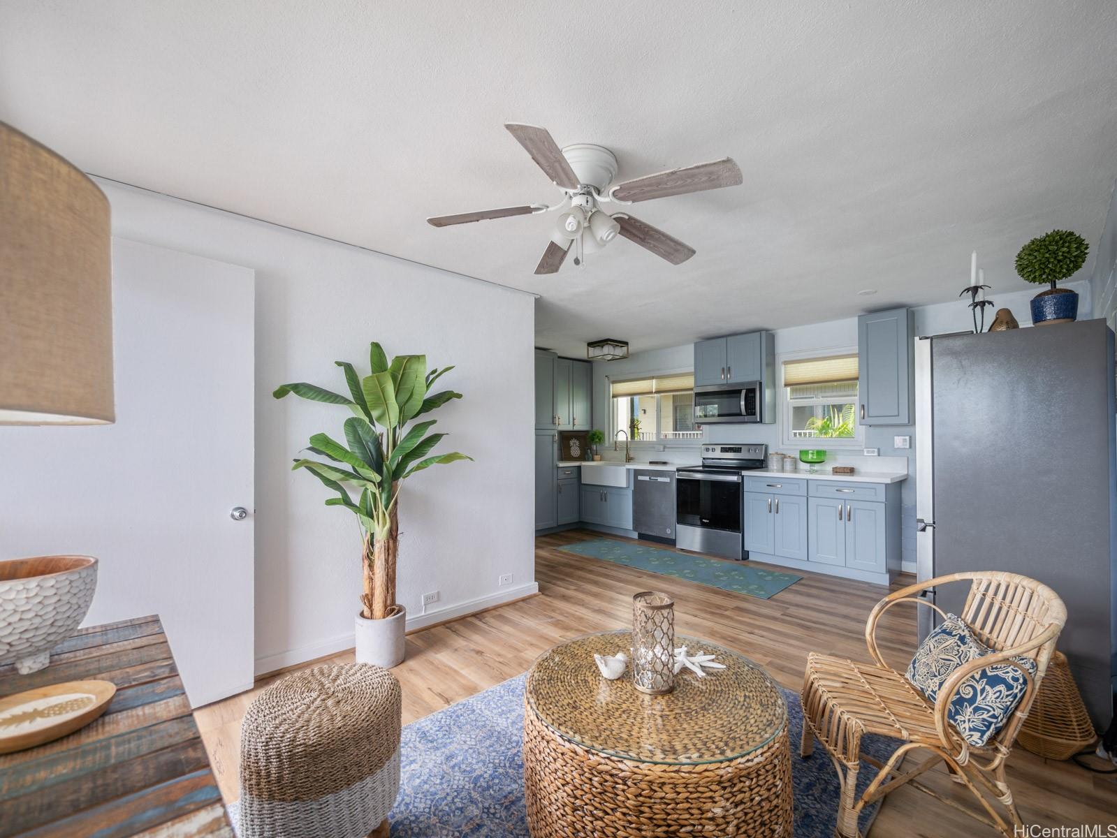 a living room with furniture and a potted plant