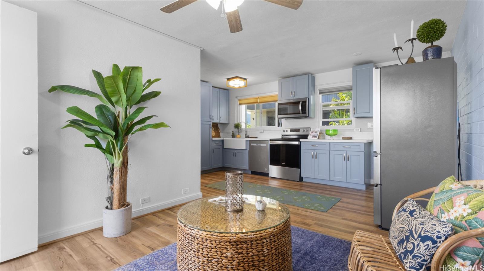 a dining room with furniture and a potted plant