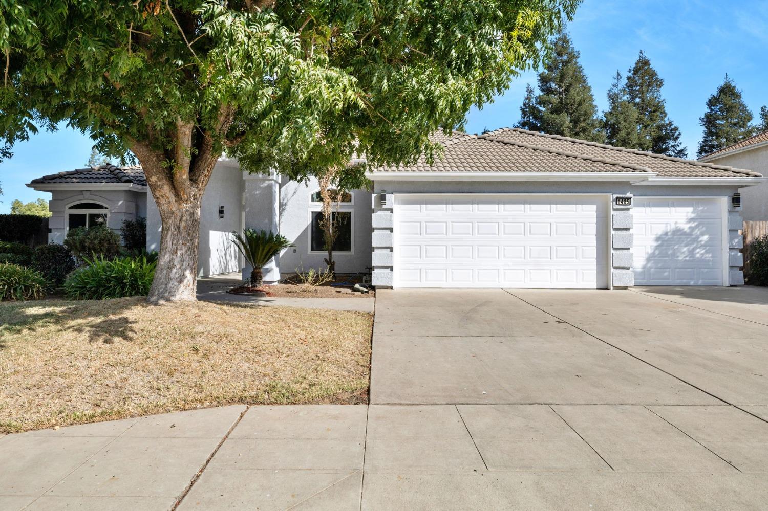 a view of a house with a yard and garage