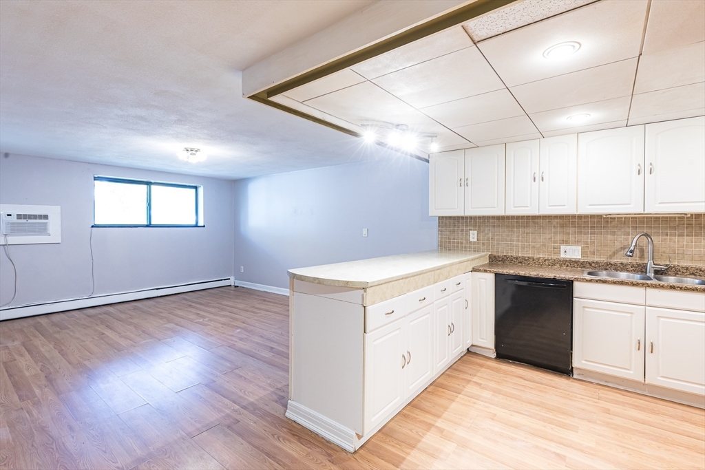 a kitchen with granite countertop white cabinets and white appliances