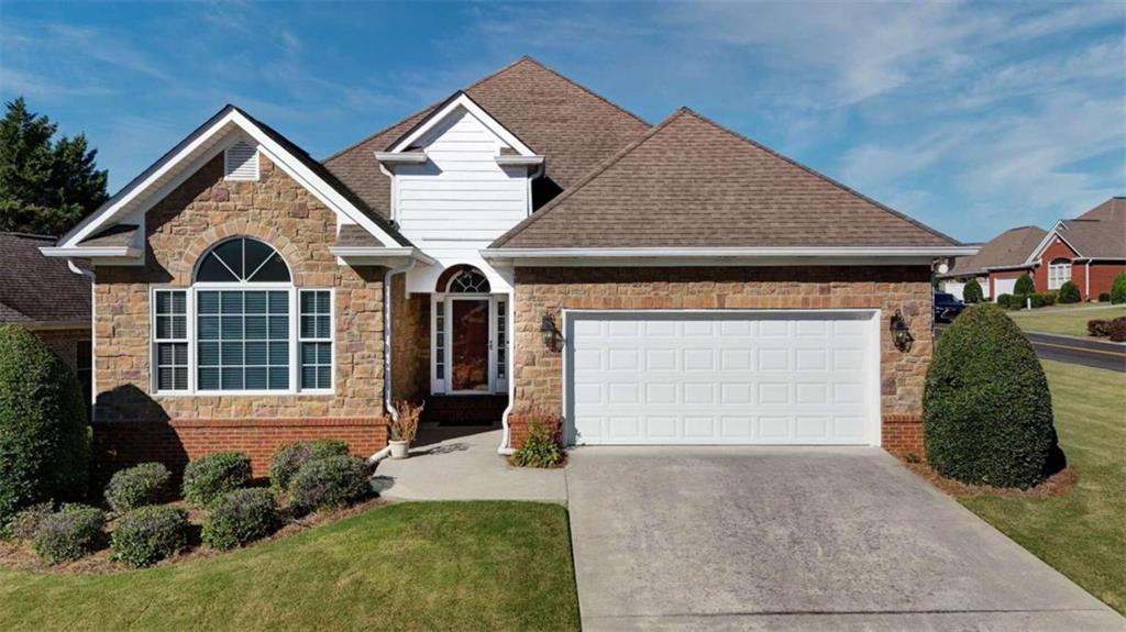 a front view of a house with a yard and garage