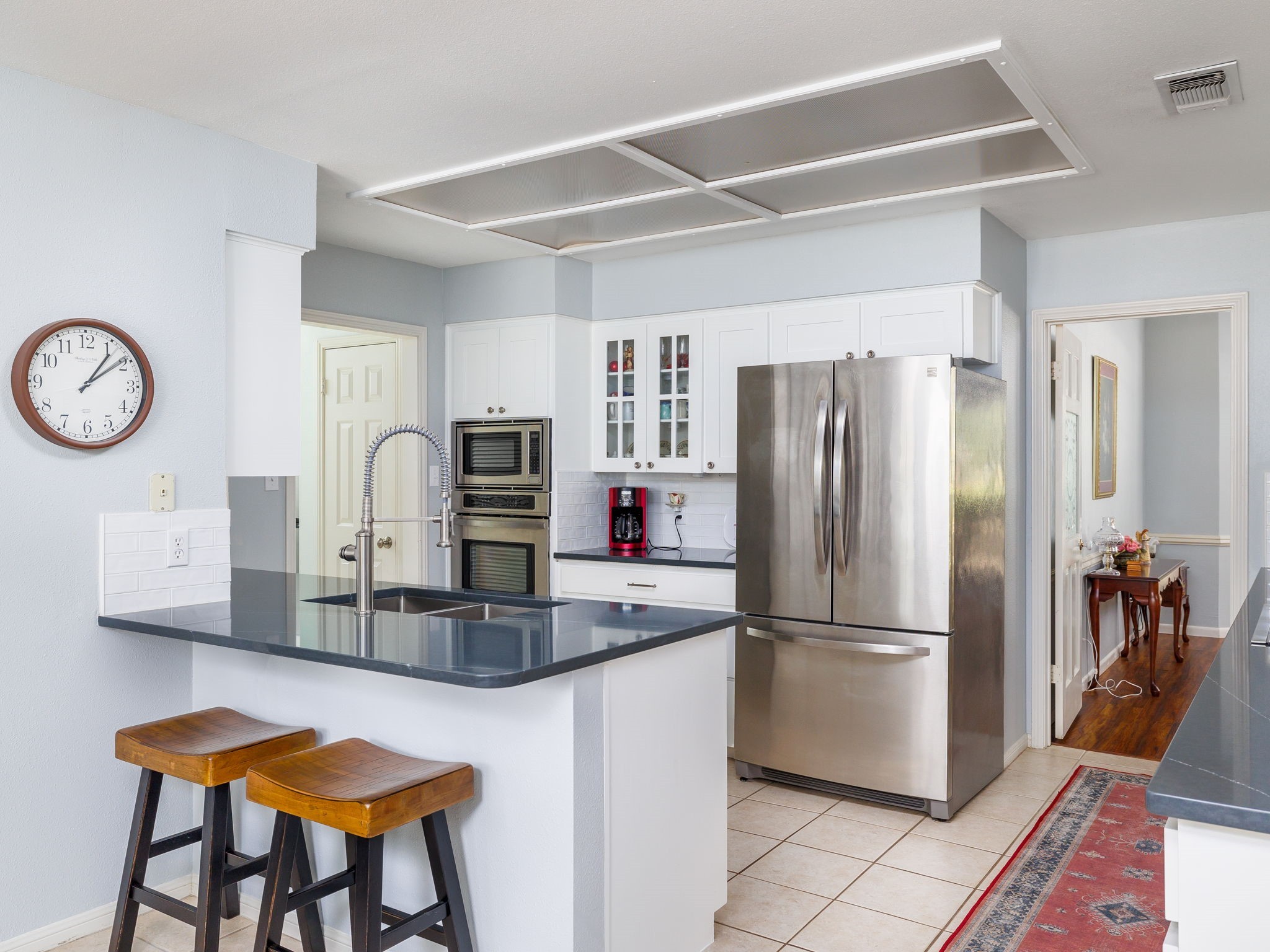 a kitchen with stainless steel appliances granite countertop a refrigerator and a stove top oven