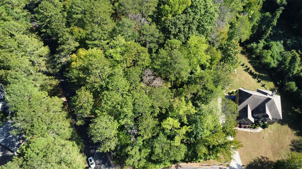 an aerial view of a house with yard