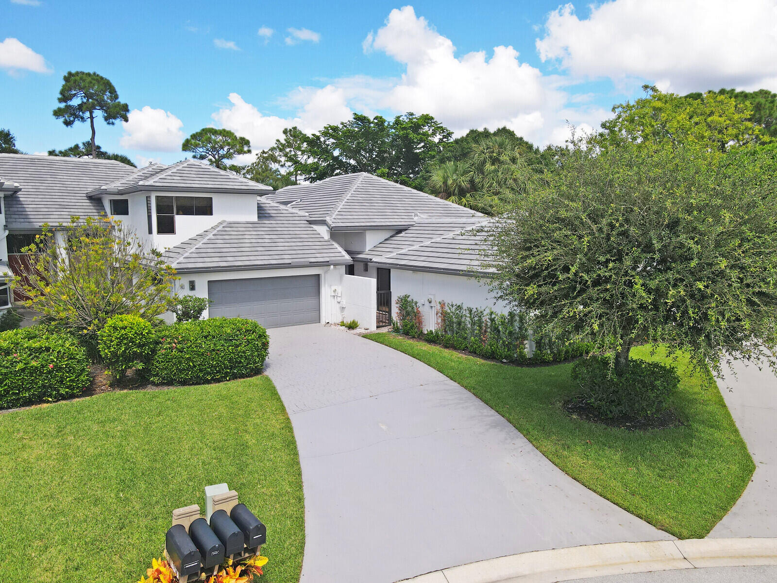 a aerial view of a house with a yard and potted plants